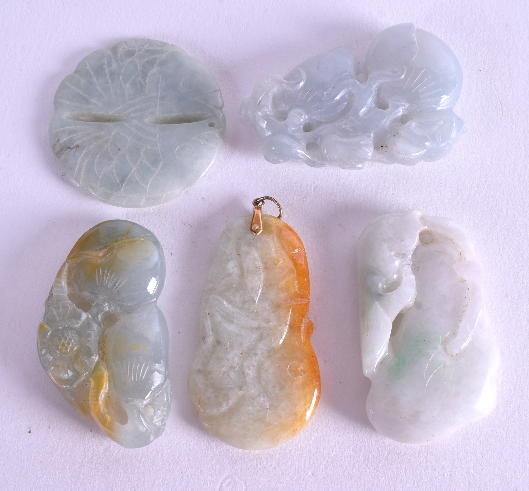 FIVE CHINESE CARVED JADEITE PENDANTS. (5)