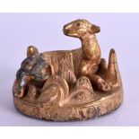 AN UNUSUAL CHINESE GILT BRONZE LEOPARD modelled upon a naturalistic outcrop. 7 cm wide.