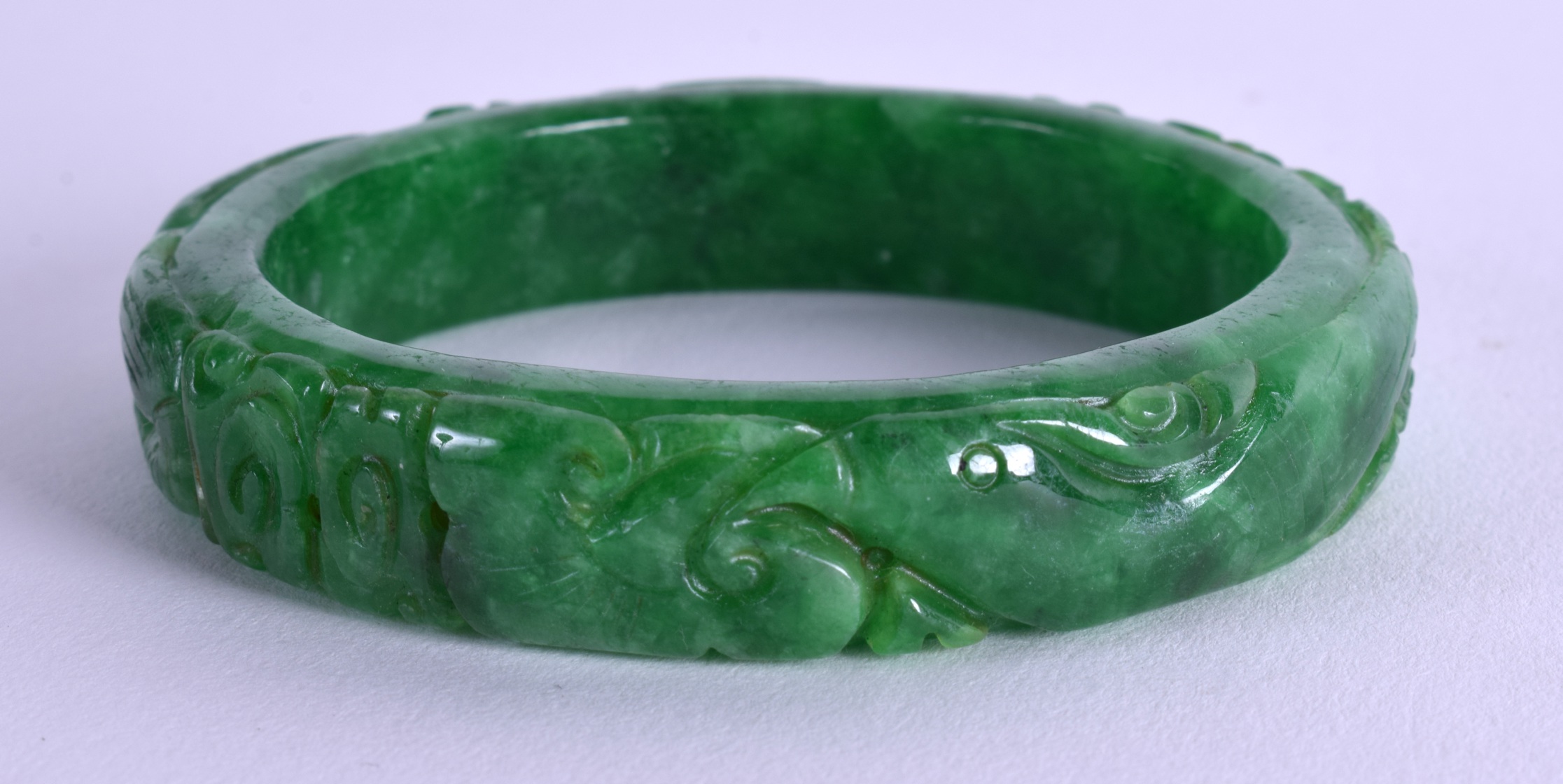 A CHINESE CARVED JADEITE BANGLE. 7.25 cm wide. - Image 2 of 3