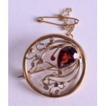 A 9CT GOLD ARTS AND CRAFTS GARNET BROOCH. 5.6 grams. 2.25 cm wide.