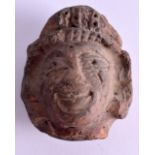 AN EARLY ANTIQUITY CARVED TERRACOTTA HEAD. 8 cm x 6.5 cm.