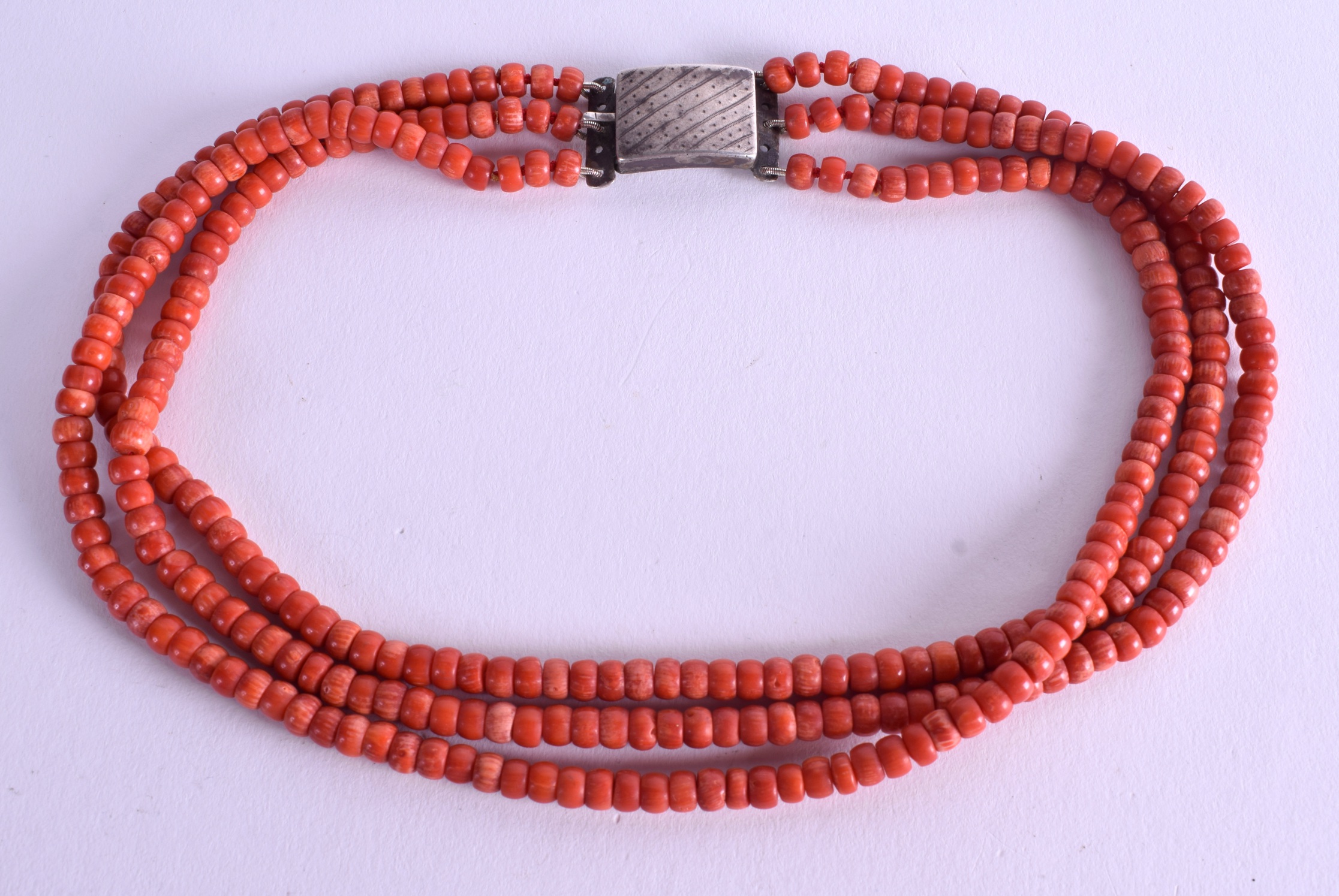 AN EARLY 20TH CENTURY SILVER AND CORAL NECKLACE. 74 grams. Each strand 36 cm long.