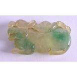 A CHINESE CARVED JADEITE BEAST AMULET. 6 cm wide.