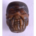 A CHINESE CARVED BUFFALO HORN TOGGLE. 3 cm x 1 cm.