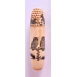 AN UNUSUAL CARVED BONE NEEDLE CASE decorated with owls. 8 cm long.