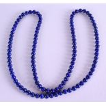 A LAPIS LAZULI NECKLACE. 60 cm long.