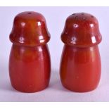 A PAIR OF ART DECO CHERRY AMBER BAKELITE CONDIMENTS. 2.75 cm high.