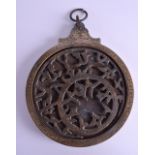 A MIDDLE EASTERN ISLAMIC ASTROLABE decorated with motifs. 18 cm x 21 cm.