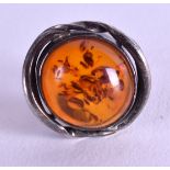 A SILVER AND AMBER RING. Size J.