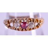 AN 18CT GOLD DIAMOND AND RUBY RING. Size O/P.