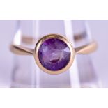 AN 18CT GOLD AND AMETHYST RING. Size Q/R.