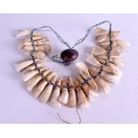 A CARVED TOOTH TRIBAL HUNTER NECKLACE. 42 cm long.