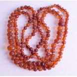 AN AMBER TYPE NECKLACE. 104 cm long.