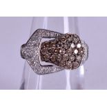 A 14CT WHITE GOLD AND DIAMOND BUCKLE RING. Size L.