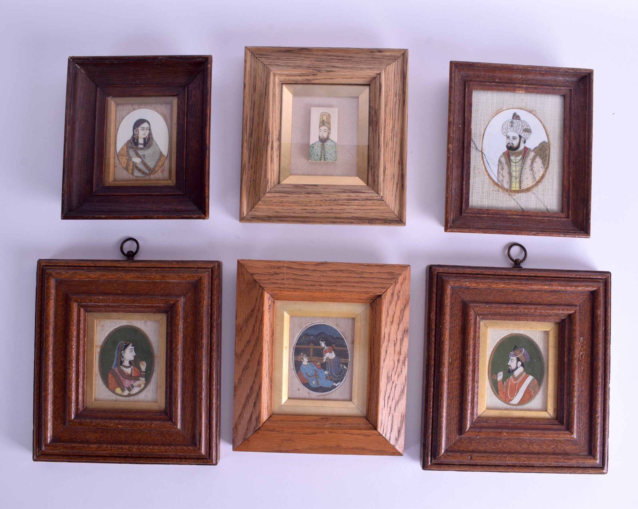 A SET OF SIX 19TH CENTURY INDIAN PAINTED IVORY PORTRAIT MINIATURES of various subjects. Largest mini