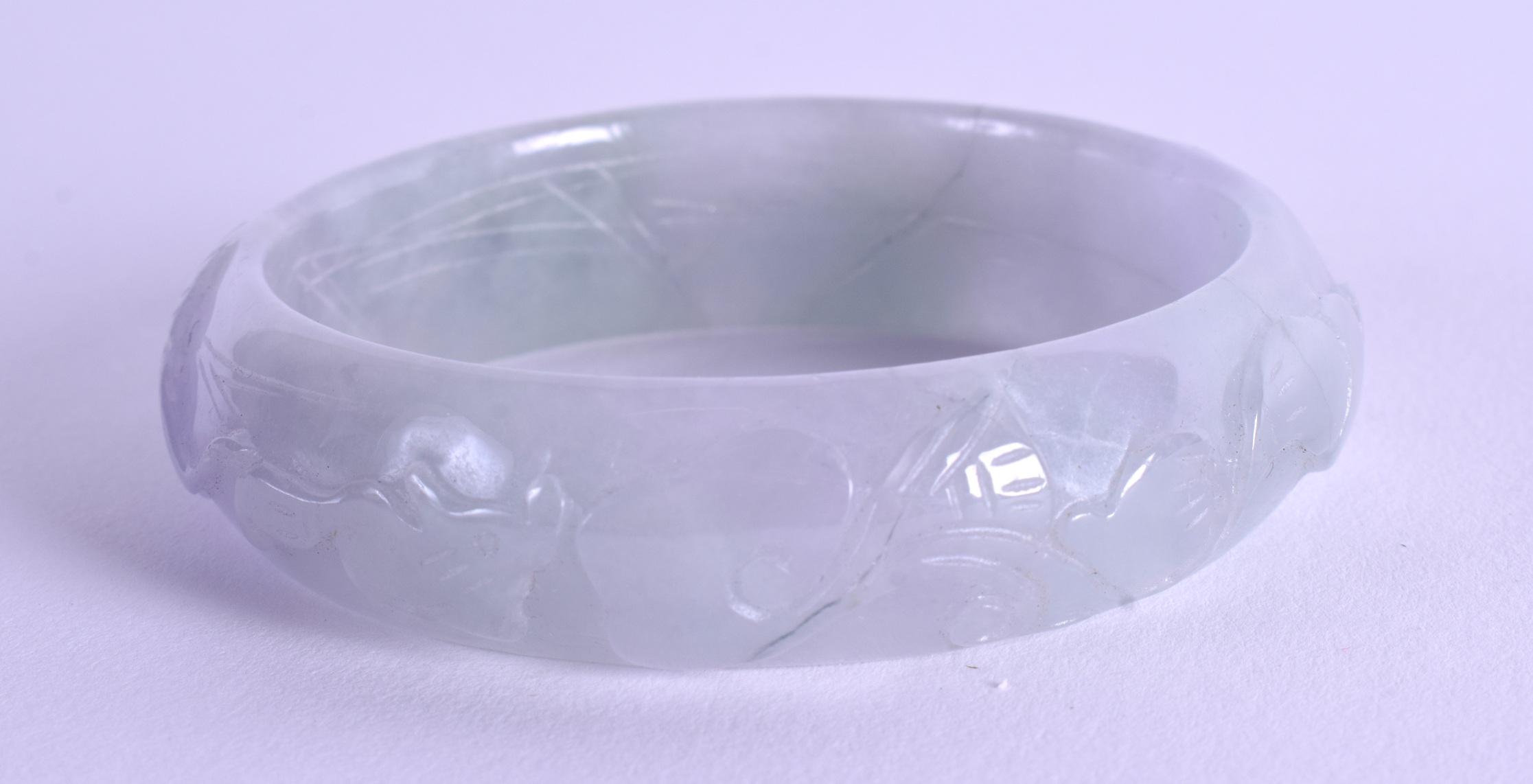 A CHINESE CARVED JADEITE BANGLE. 7 cm wide. - Image 2 of 3