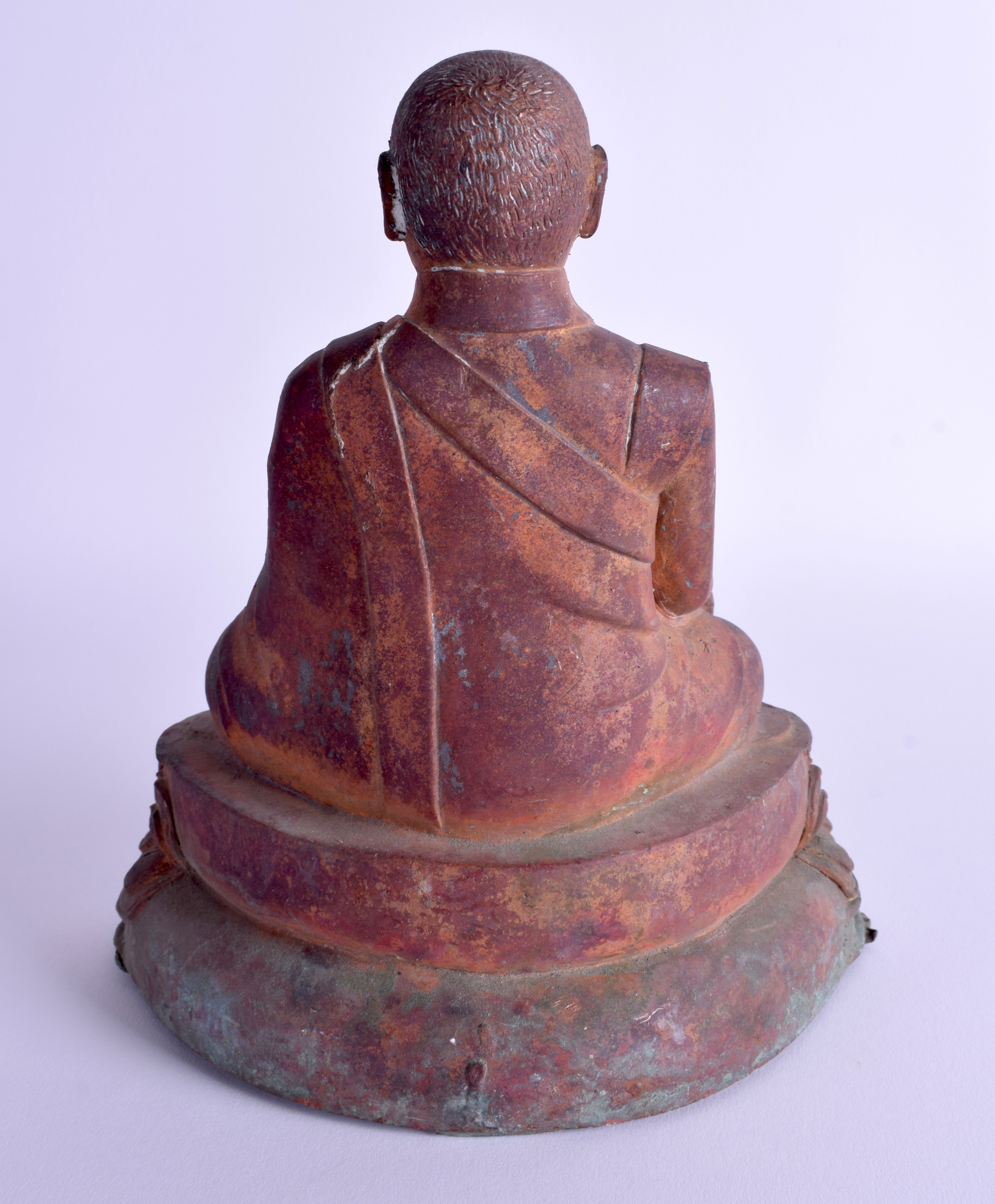 A CHINESE TIBETAN QING DYNASTY BRONZE FIGURE OF A BUDDHA modelled upon a triangular lotus base. 21 c - Image 2 of 3