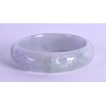 A CHINESE CARVED JADEITE BANGLE. 7 cm wide.