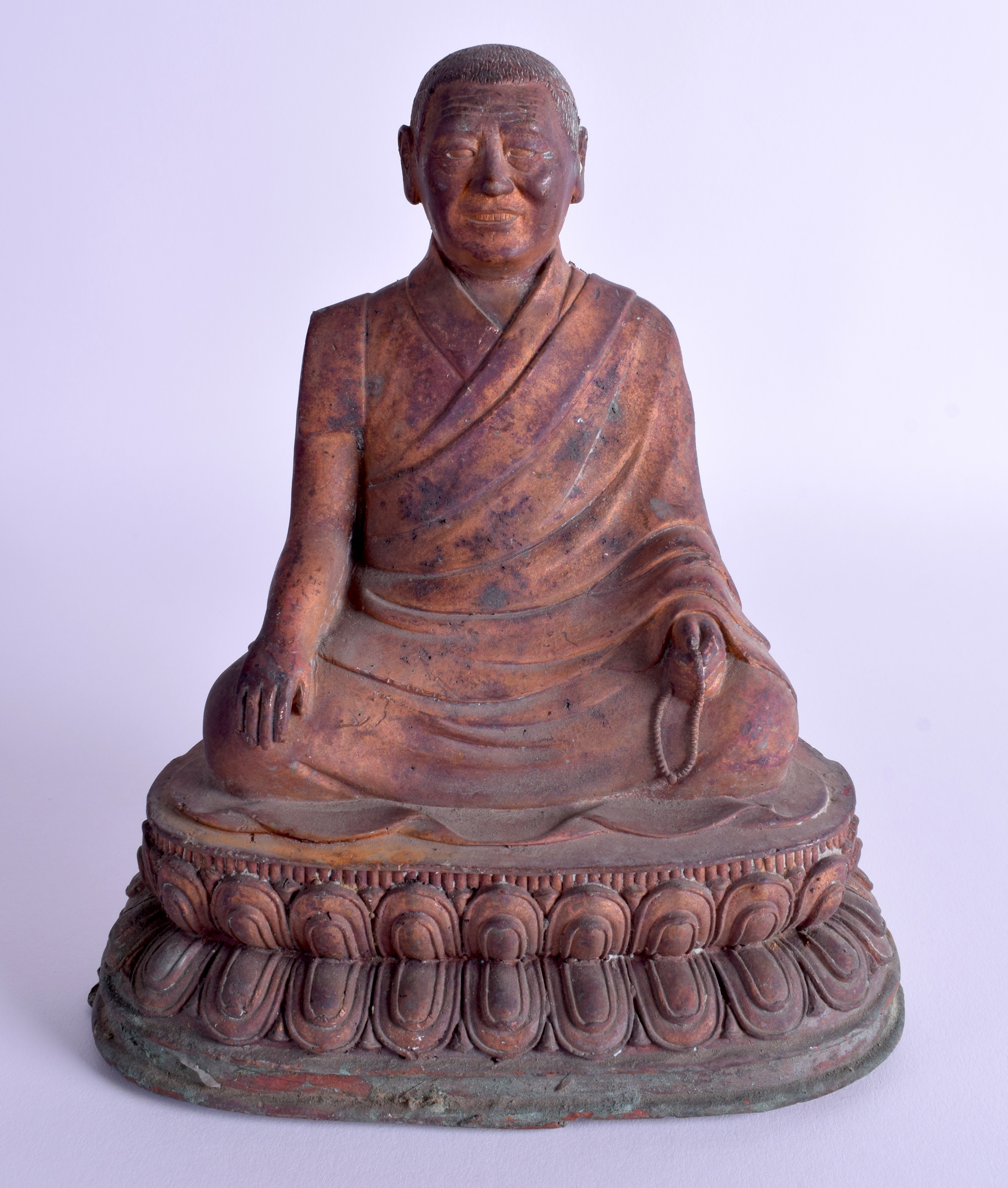 A CHINESE TIBETAN QING DYNASTY BRONZE FIGURE OF A BUDDHA modelled upon a triangular lotus base. 21 c