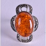 A SILVER AND AMBER RING. Size O.