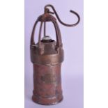 AN ANTIQUE BRONZE AND CAST IRON MINERS LANTERN with applied plaque '333'. Lamp 28 cm high.