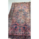 AN ANTIQUE CAUSION RUG, decorated with foliage. 186 cm x 110 cm.