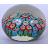 AN EARLY 20TH CENTURY MILLIFIORE GLASS PAPERWEIGHT, formed with multicoloured foliage. 7.75 cm wide.