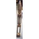 A CARVED AFRICAN WOODEN TRIBAL STATUE OR FIGURE, formed as an elongated male with hands on hips. 94.