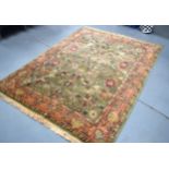 A GREEN GROUND TURKISH OUSHAK RUG, decorated with foliage. 170 cm x 230 cm.