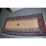 AN UNUSUAL CAMEL GROUND TRUBAL SOUMAC RUNNER RUG, decorated with central motif. 210 cm x 87 cm.