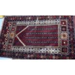 A 20TH CENTURY BALUCH PRAYER RUG, decorated with symbols. 138 cm x 82 cm.