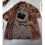 A VINTAGE LADIES FUR COAT BY COOKS WOLVERHAMPTON, together with an evening clutch bag. (2)