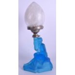 A 1930S CZECH BLUE GLASS FIGURE OF A SEATED FEMALE modelled holding aloft a lamp. 36 cm high.