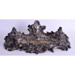 AN EARLY 19TH CENTURY FRENCH SILVERED BRONZE INKWELL of scrolling rococo form. 42 cm x 20 cm.