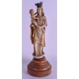 AN EARLY 18TH CENTURY EUROPEAN CARVED IVORY FIGURE OF MADONNA modelled holding a child wearing a cro