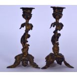 A PAIR OF EARLY 20TH CENTURY BRONZE CANDLESTICK HOLDERS FORMED AS MONKEYS, modelled clinging to the