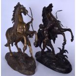 A LARGE PAIR OF SPELTER FIGURINES OF MALES BESIDE REARING HORSES, modelled upon naturalistic outcrop