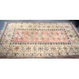 A 20TH CENTURY MUTED TURKISH RUG, decorated with geometric motifs. 212 cm x 123 cm.