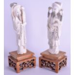 A PAIR OF EARLY 20TH CENTURY CHINESE CARVED IVORY IMMORTALS modelled holding scrolls. Ivory 16 cm hi