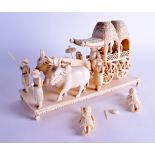 A LARGE 19TH CENTURY INDIAN CARVED IVORY FIGURE OF A PROCESSION modelled with two cows pulling along