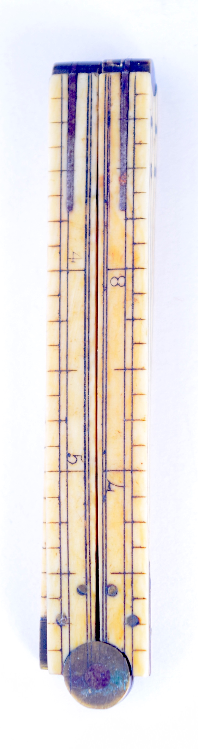 A VICTORIAN IVORY FOLDING RULE, formed with brass mounts and hinge. 30.5 cm wide. - Image 2 of 2