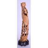 A 19TH CENTURY CHINESE CARVED IVORY FIGURE OF A HOHO BIRD modelled holding a floral sprig within its