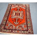 AN EARLY 20TH CENTURY RED GROUND PERSIAN SHRAB RUG, decorated with symbols. 150 cm x 100 cm.