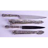 TWO 19TH CENTURY SILVER KNIVES decorated with heraldic beasts and foliage. 32 cm & 25 cm wide. (2)