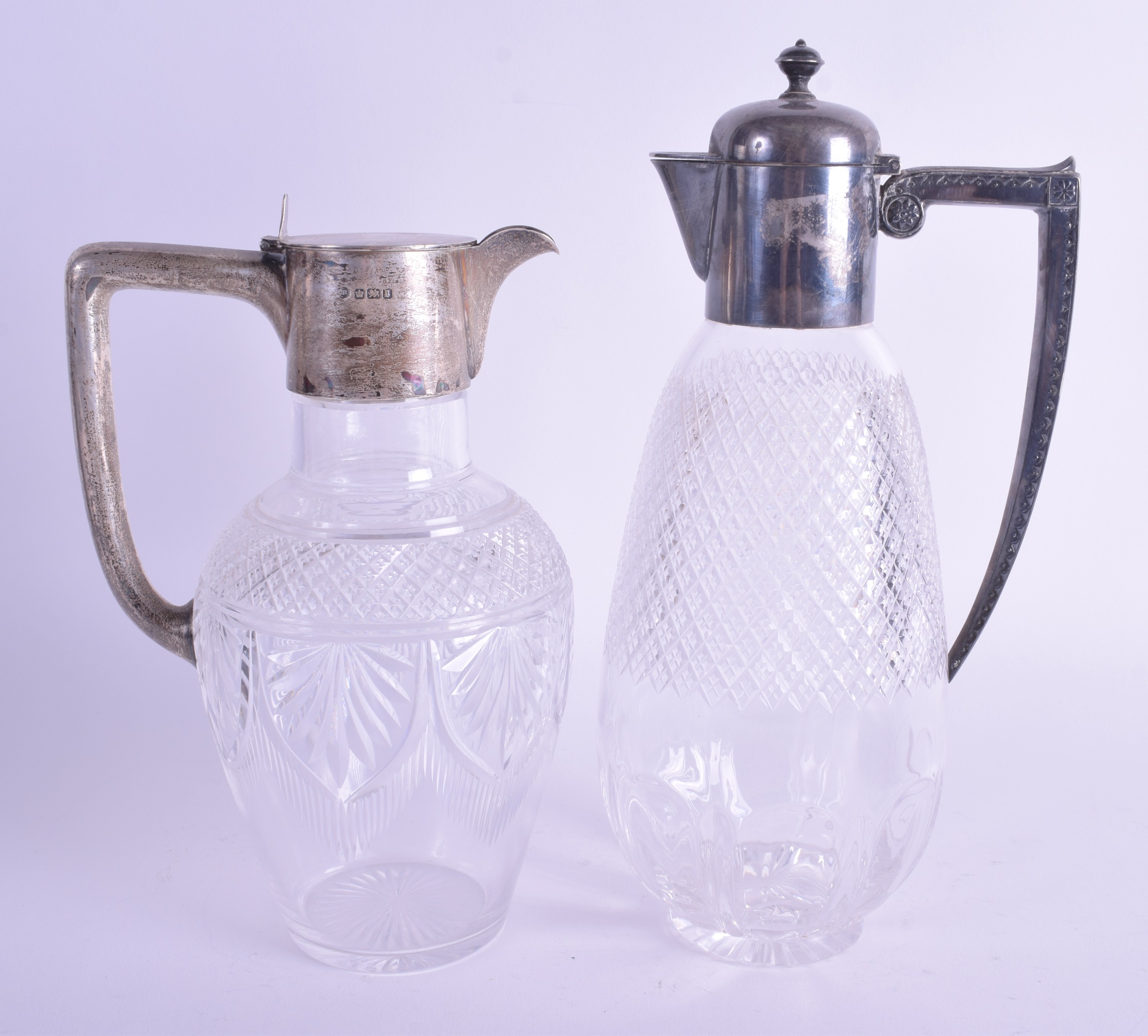 TWO ANTIQUE SILVER AND CUT GLASS CLARET JUGS. 27 cm & 22 cm high. (2)