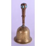 A 19TH CENTURY INDIAN BRASS AND TURQUOISE BELL engraved with foliage. 11 cm high.