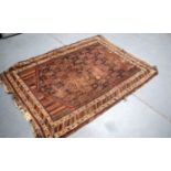 AN ANTIQUE CAUCASION GENDJE RUG, decorated with stylised foliage. 170 cm x 128 cm.