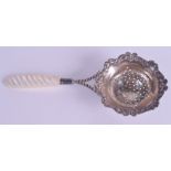 A SILVER AND PEARL STRAINING SPOON.