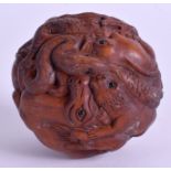 A JAPANESE CARVED WOOD BALL. 6.5 cm wide.