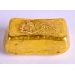 A CHINESE YELLOW METAL INGOT. 87 grams. 3.75 cm x 2 cm.